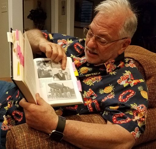 Will Frome points to a photo he remembers from long ago in a book his father wrote in 1974. The book is Battle for the Wilderness by Michael Frome.