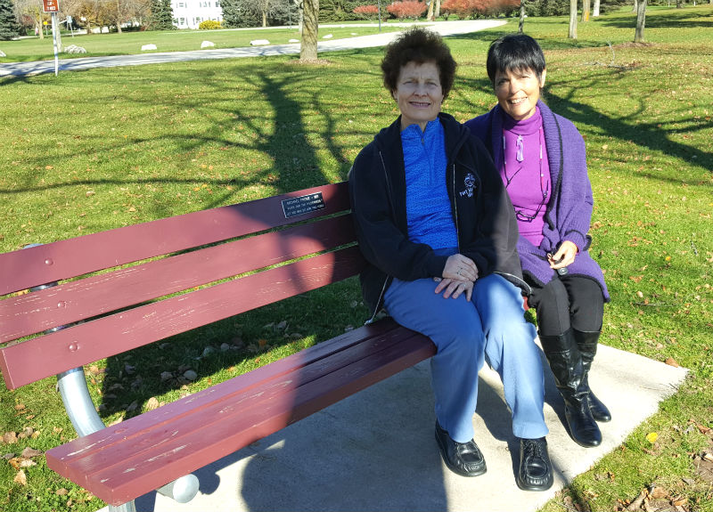Michele Frome sits with Gaye Lyn on the bench celebrating Michele's father's 90th birthday.