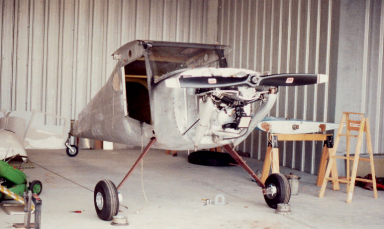 A wingless bird, John Noll's Cessna 120 sits with no wings and no doors in a hangar where John was rebuilding it.