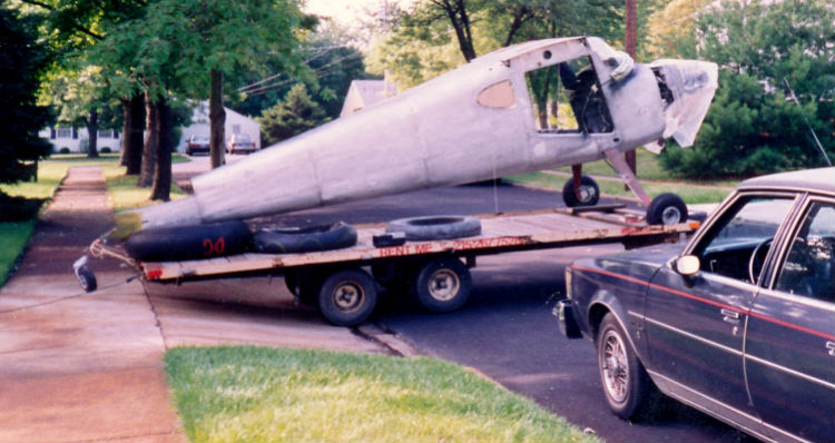  Striped of wings and doors, John Noll's Cessna 120 sits atop a pull trailer for the NJ to FL trip.